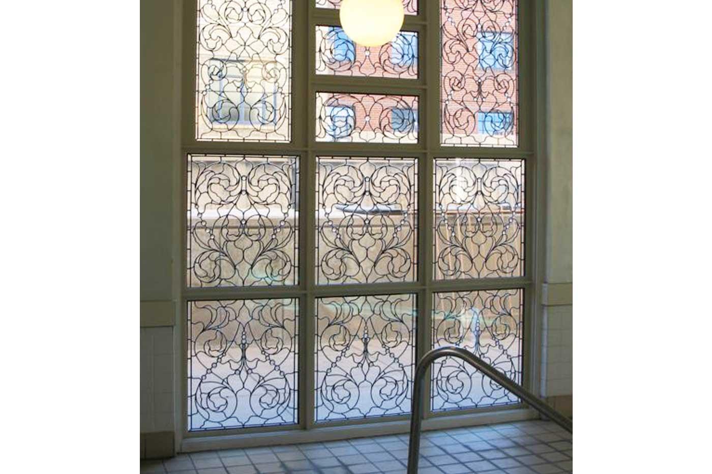 Without the use of color, Wolff is able to add intrigue and dimension to a window through her intricate designs.