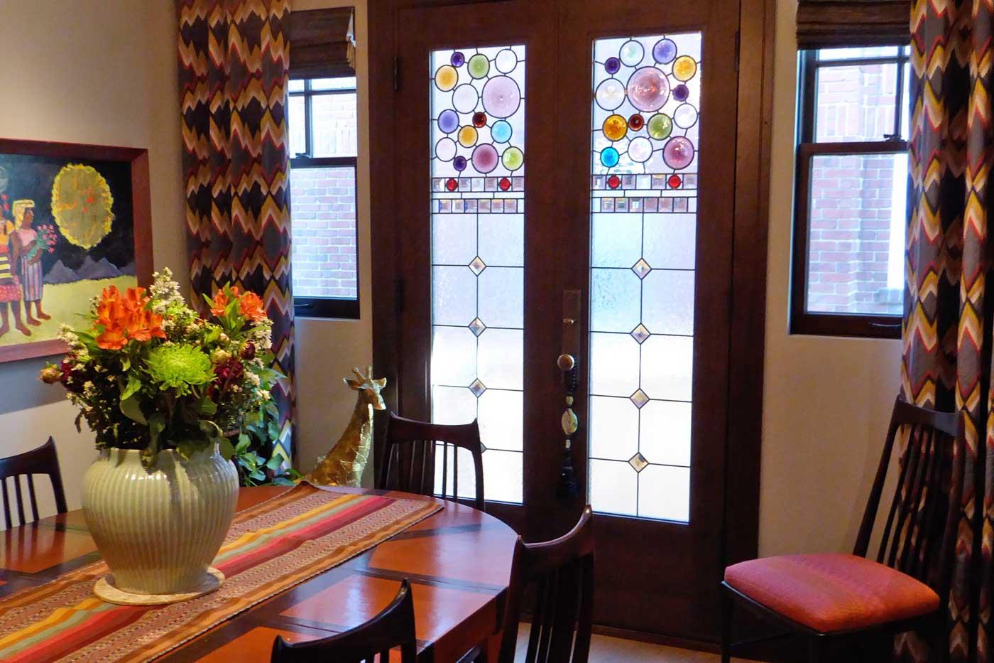 Roundels in custom stained glass doors by Ann Wolff.
