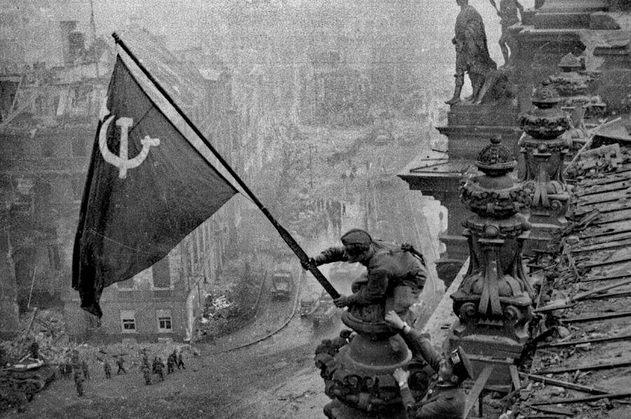 Yevgeny Khaldei, Raising a flag over the Reichstag, May 2, 1945.