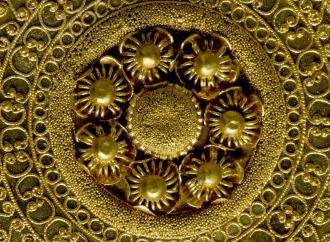 Detail shot of a gold ear-stud: disc decorated with granulation, filigree and beaded wire. 530BC-500BC