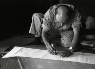 Isamu Noguchi working on a paper template for an Akari design, 1952. The Noguchi Museum Archives, 03603. 