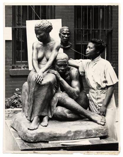 PHOTO BY ANDREW HERMAN, CIRCA 1938. WIKIMEDIA COMMONS Augusta Savage posing with her sculpture Realization, created as part of the Works Progress Administration's Federal Art Project. 