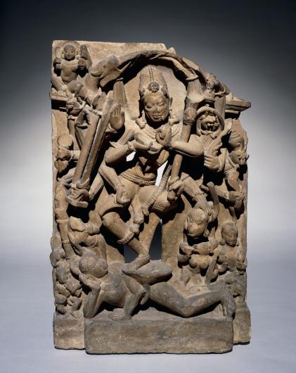 stone carving statue of figures dancing