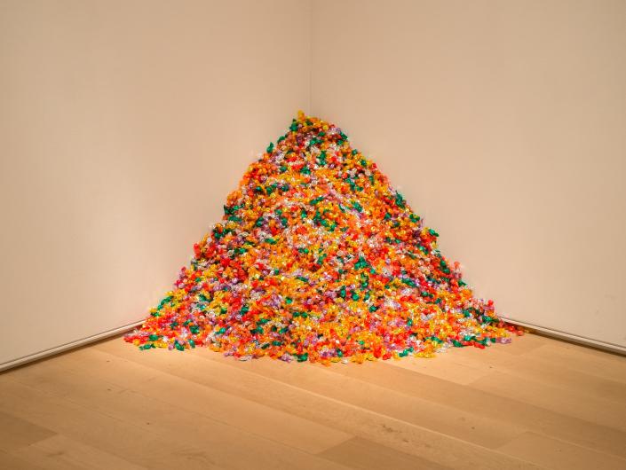Felix Gonzalez-Torres conceptual art work- a pile of colorfully wrapped candies piled in the corner of an art gallery