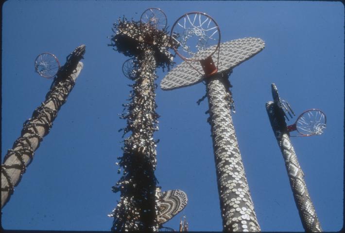 basketball goals covered in various detritus and shot from ground view, at the base of the post. 