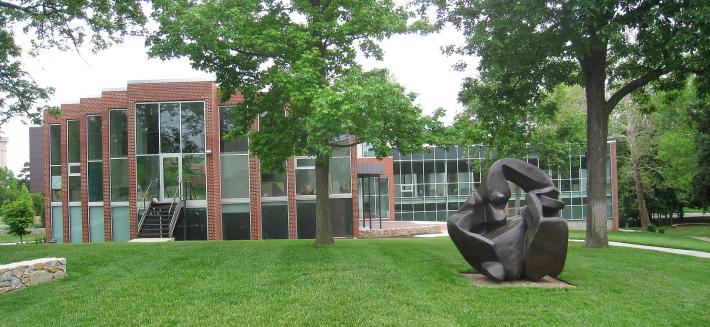 Kansas City Art Institute lawn with a large bronze organic sculpture and brick building