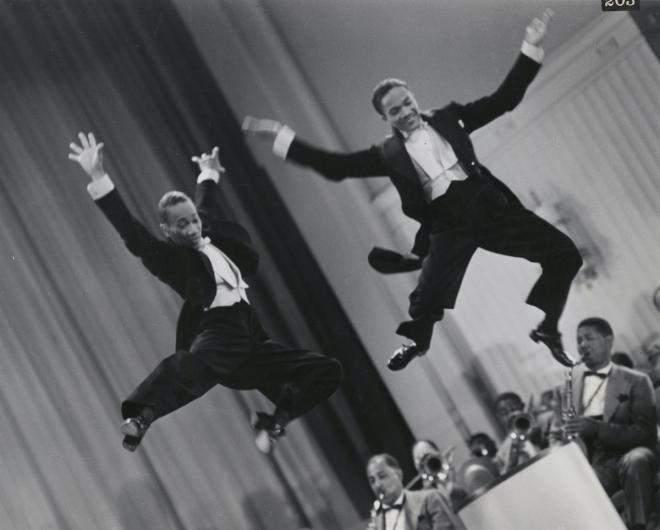 The Nicholas Brothers in a scene from Stormy Weather (1943), from left, Fayard Nicholas and Harold Nicholas. Photographic print, gelatin silver. 