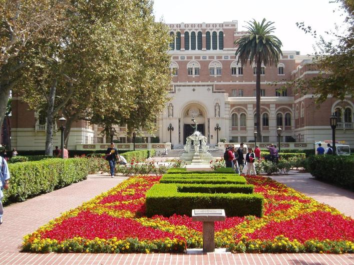 USC hall with many red flower beds and sidewalks