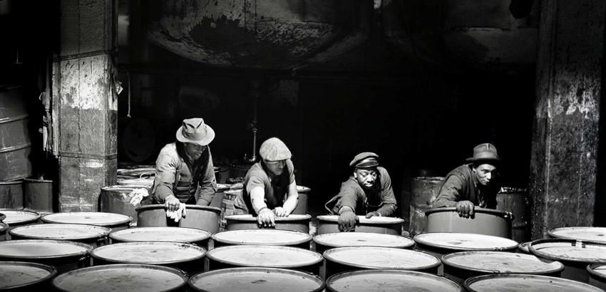 "Workmen stacking drums of grease ready for shipment.", March 1944